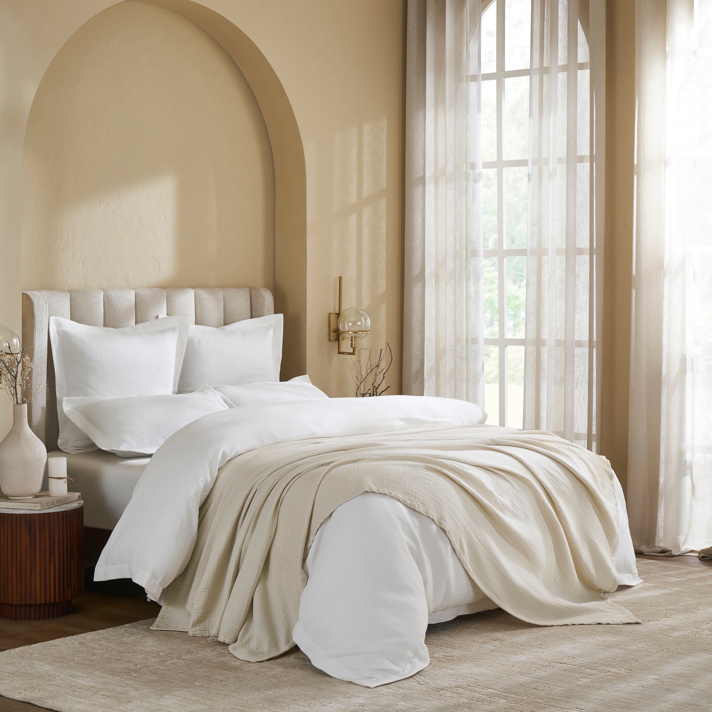 BL-862-11096_3|Cream textured cotton blanket draped elegantly over a pristine white bed, adding a touch of warmth and sophisticated comfort to the bedroom.