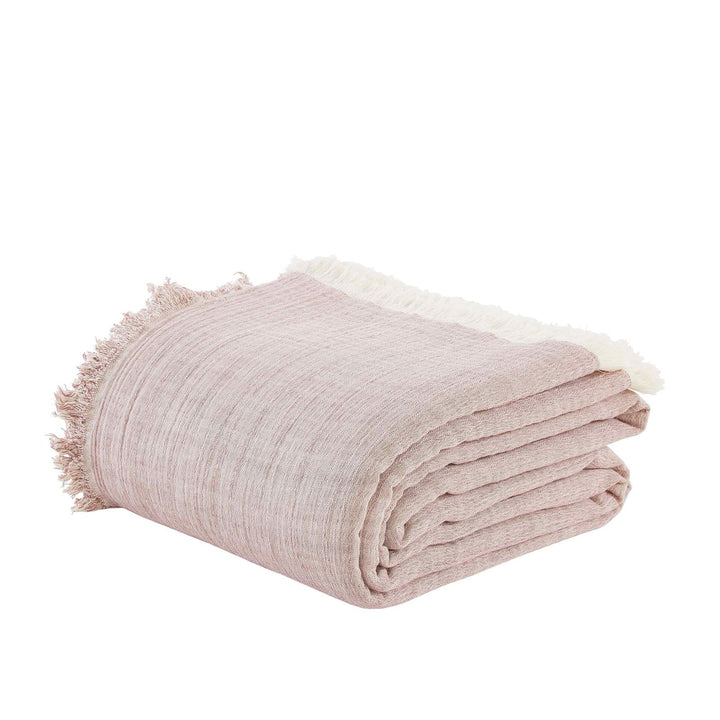 BT-110-9496_3|Neatly folded blush pink textured cotton blanket with fringed edges, perfect for adding cozy warmth to any space.