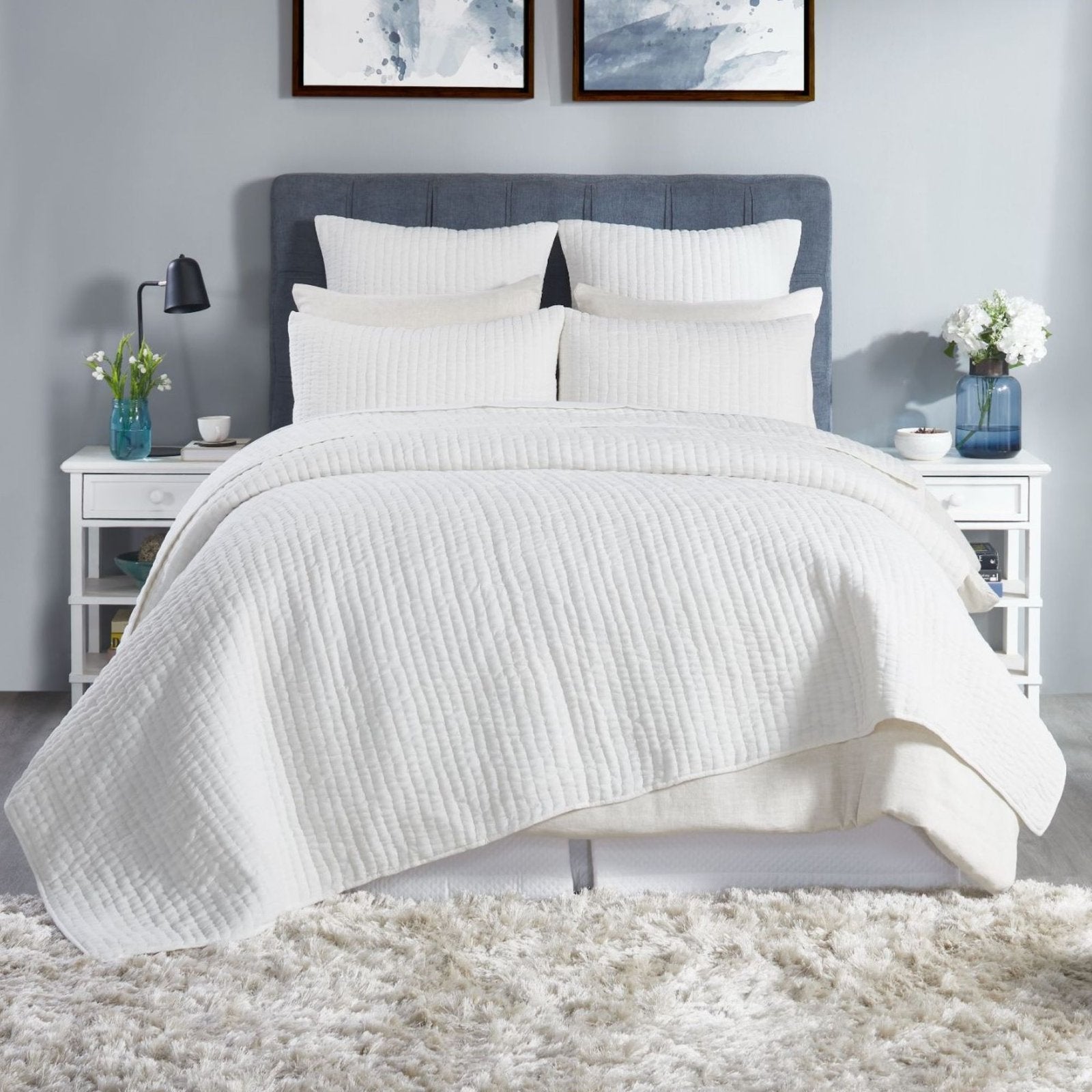 QT-359-9496-LOT1_1|Crisp white quilted duvet cover and shams adorning a stylish bedroom setting. Textured cotton quilt adds comfort and elegance.