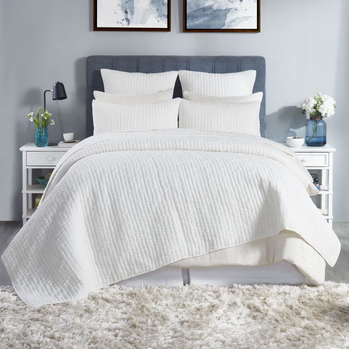 QT-359-9496-LOT1_1|Crisp white quilted duvet cover and shams adorning a stylish bedroom setting. Textured cotton quilt adds comfort and elegance.