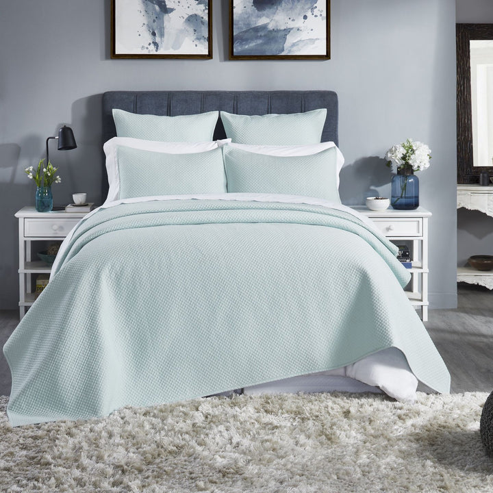 CL-252-11096_1|Refreshing mint green quilted coverlet adorning a stylish bed, offering cozy comfort and elegant modern bedroom appeal.