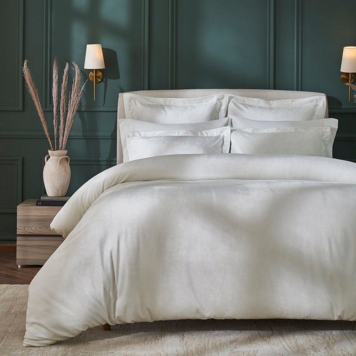 DT-052-9092_1|White textured duvet cover with subtle ribbed pattern, enhancing an elegant bedroom with dark green walls, inviting comfort.