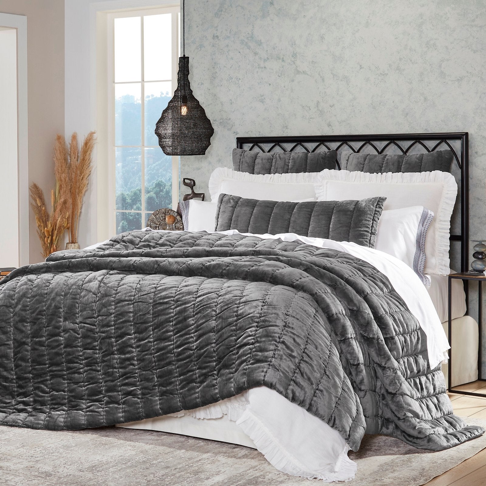 QT-338-11096_2|Chic dark grey velvet quilt featuring channel quilting, elegantly draped on a bed for a sophisticated, cozy look.