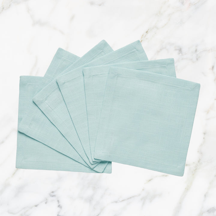 CNP-4903-66_1|Fanned set of elegant light blue linen napkins on white marble. Perfect for contemporary dining & sophisticated gatherings.