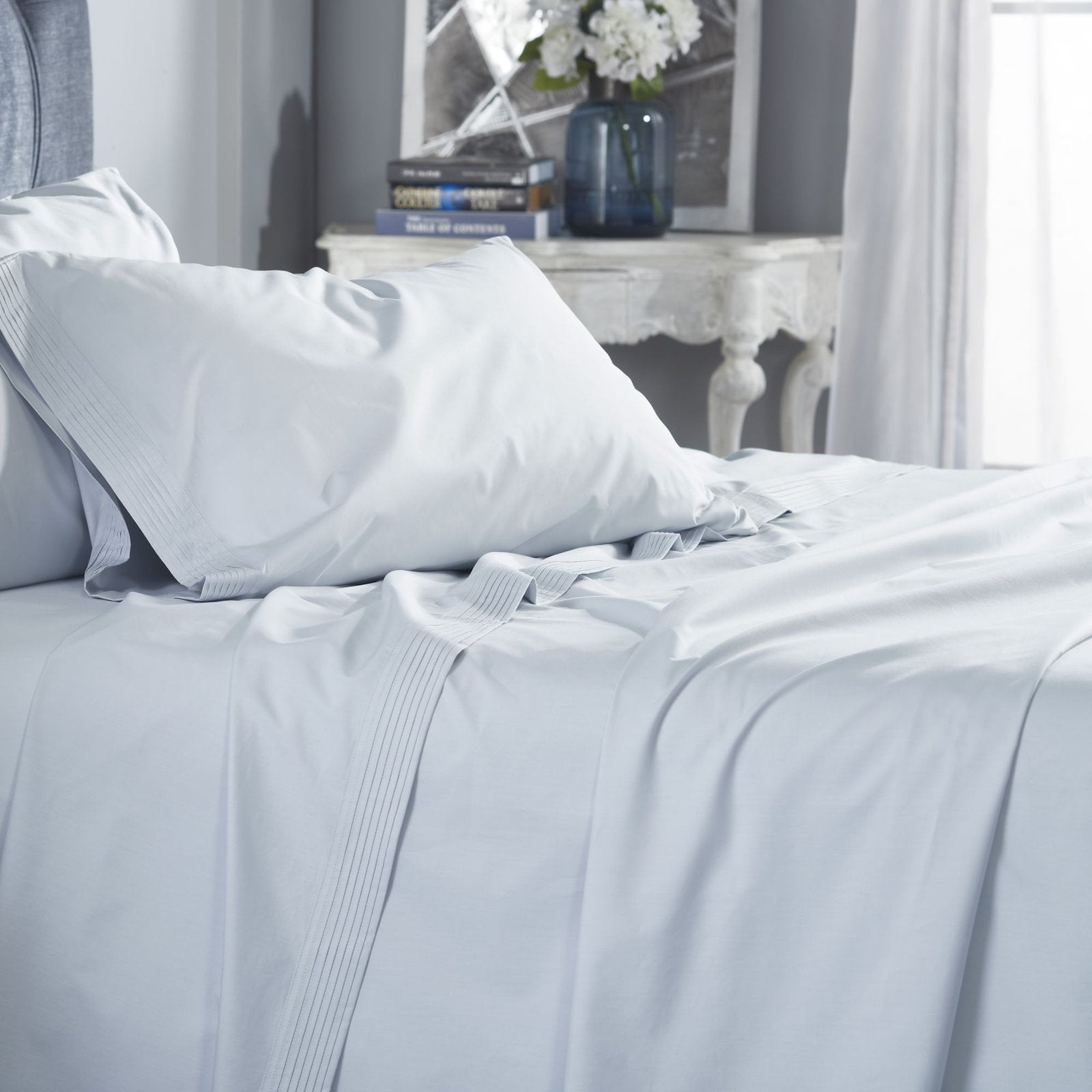 QSS-524-6080_4|Smooth light blue 100% cotton sheets and pillowcase on a bed, featuring elegant pleated accents for serene comfort.