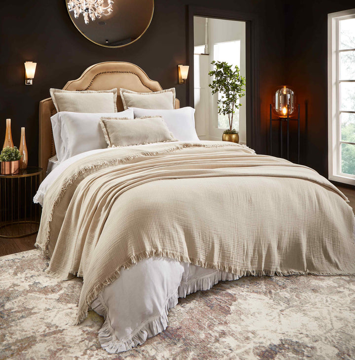 BT-114-9496_1|Luxurious beige textured blanket with a stylish fringe edge draped over a bed, adding warmth and elegance to modern bedroom decor.