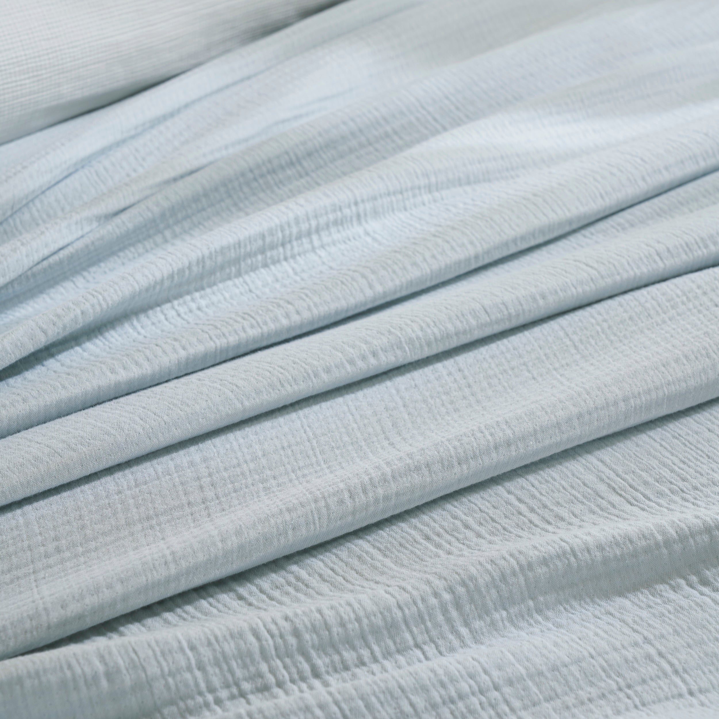 BL-863-9496_5|Close-up of soft light blue muslin gauze blanket texture, highlighting its breathable, lightweight feel for ultimate comfort.