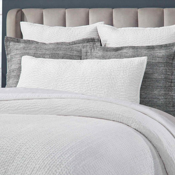 CL-182-9496_4|Close-up of white textured coverlet and matching quilted pillows, luxurious bedding detail for a serene bedroom. (119 chars)