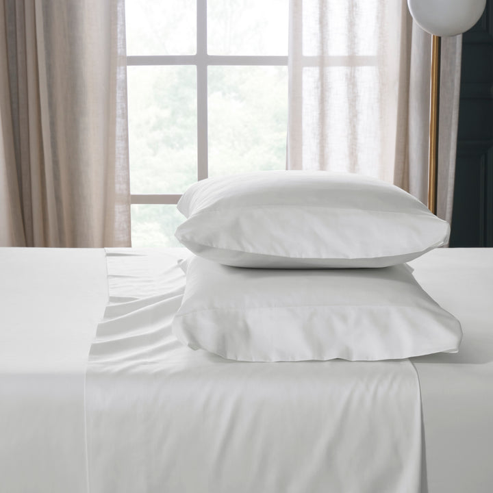 KSS-539-7880_2|Crisp white 100% cotton sheets and pillows on a bed, offering luxurious softness and breathability for ultimate comfort.