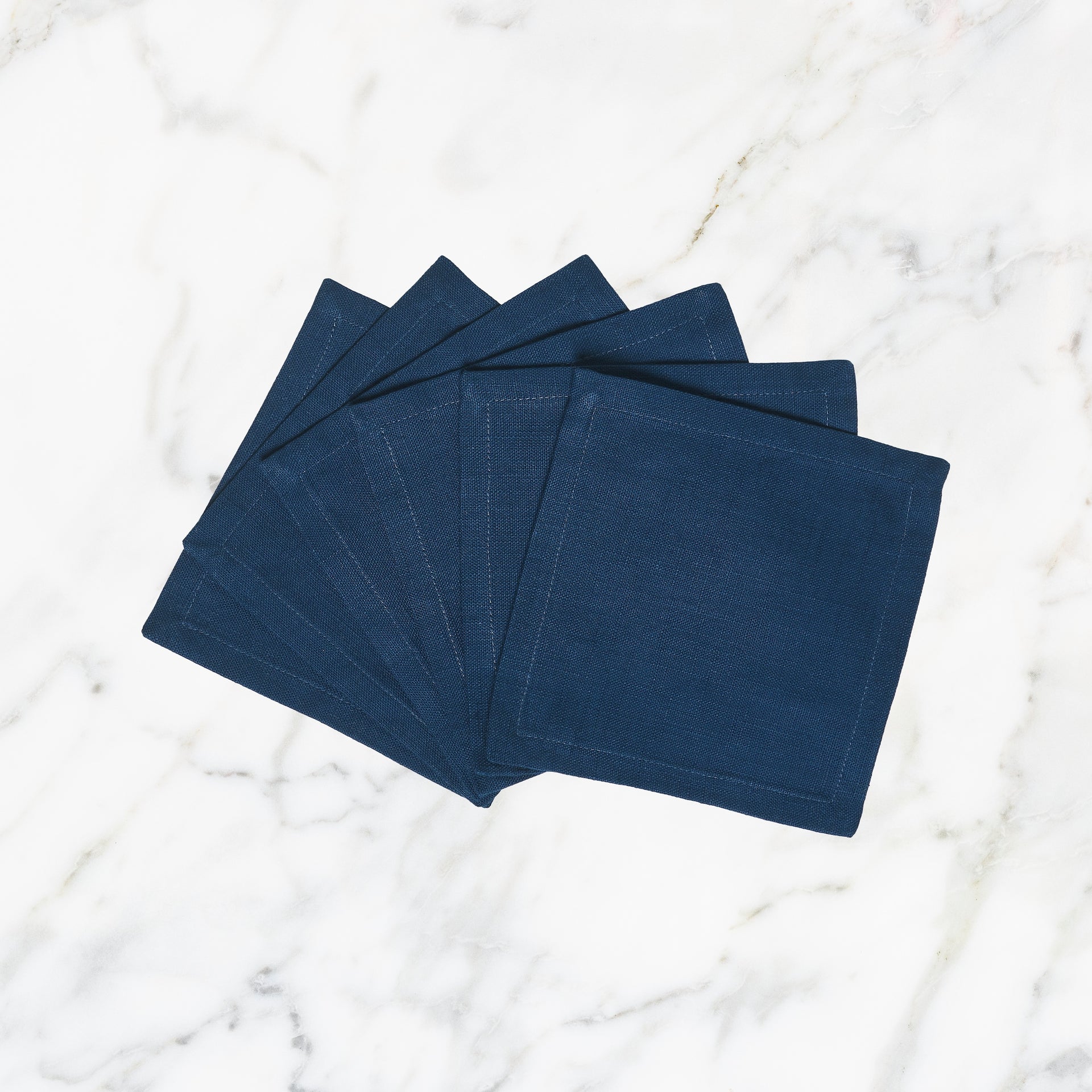 CNP-4901-66_1|Set of deep blue linen dinner napkins arranged in a fan, perfect for elegant table settings and everyday use.