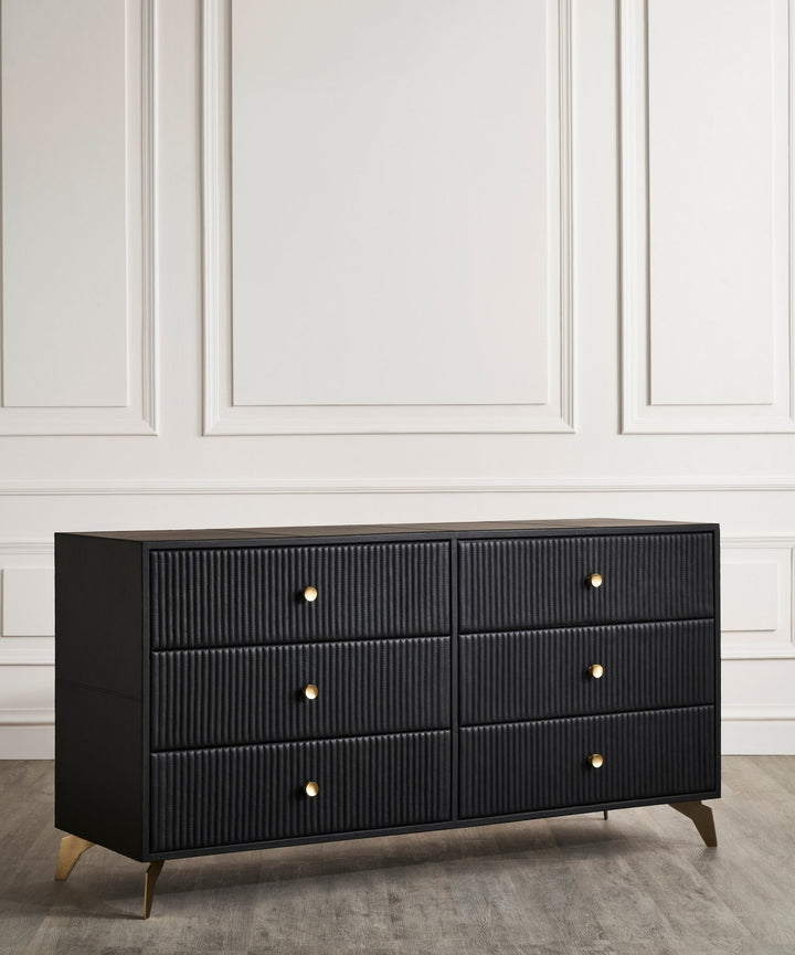 FN-5202-642033_4|Angled view of a sleek black modern dresser with textured fluted fronts, six drawers, and chic gold hardware.